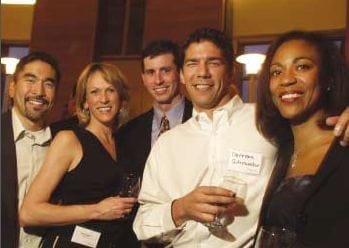 Five alumni pose together for a photo at Reunion.