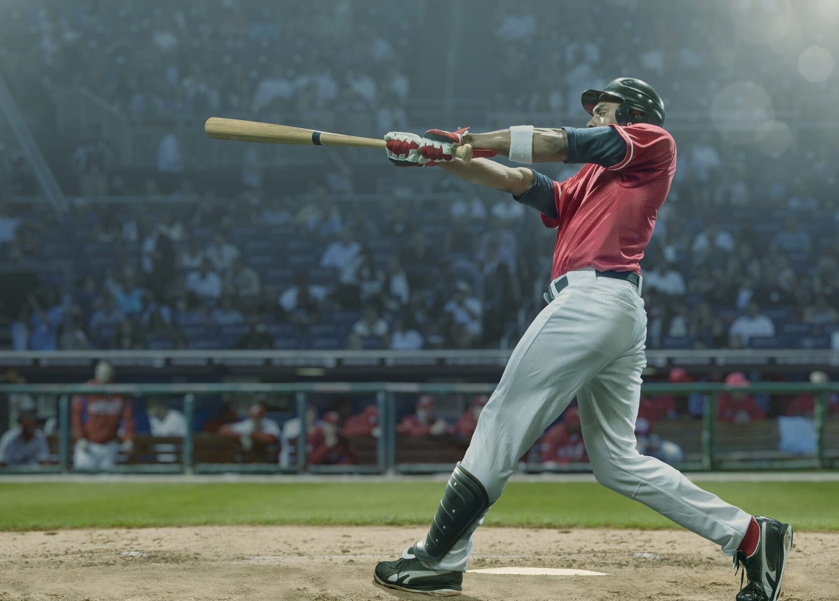 A baseball player hitting a baseball with a bat.