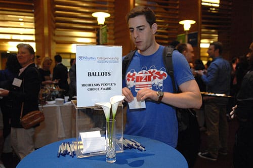 An attendee casts a vote during the Elevator Pitch Competition for the Michelson People’s Choice Award