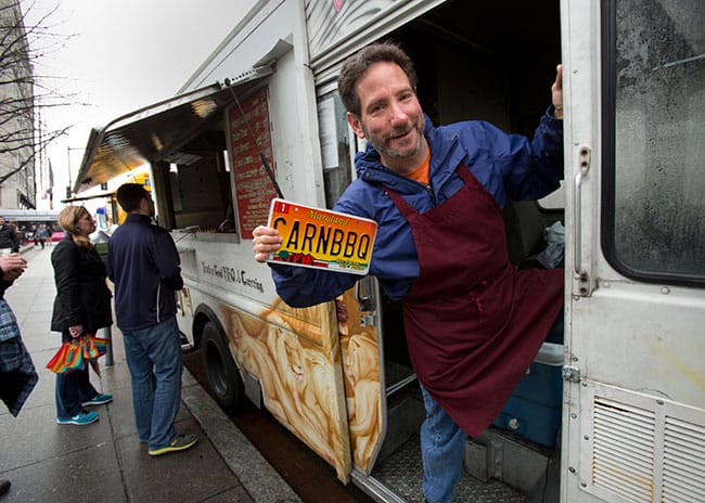 Stephen Adelson, WG’90, serves up authentic BBQ to lines of hungry DC diners. Photo credit: Mark Finkenstaedt.