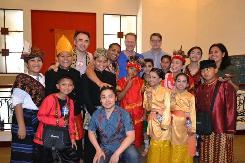 Glowing Indonesian children with their Wharton guests during the Wharton international business course