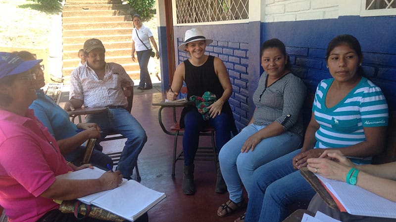 The author (center, in hat) on assignment during a social impact project in Latin America , where she learned the business power of empathy.