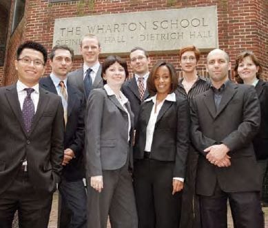 Group of people in suits in front of Wharton's Steinberg Hall-Dietrich Hall building