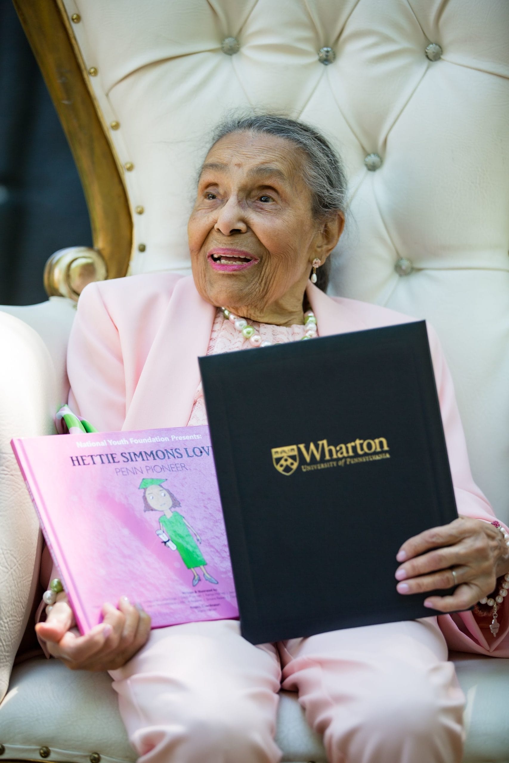 Hettie Simmons Love holds book and Penn Pioneer certificate