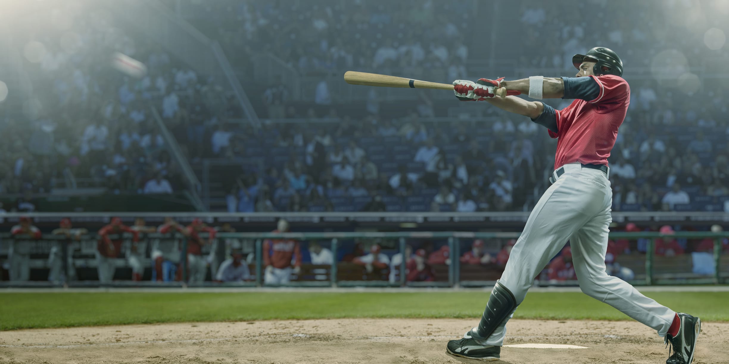 A baseball player hitting a baseball with a bat.