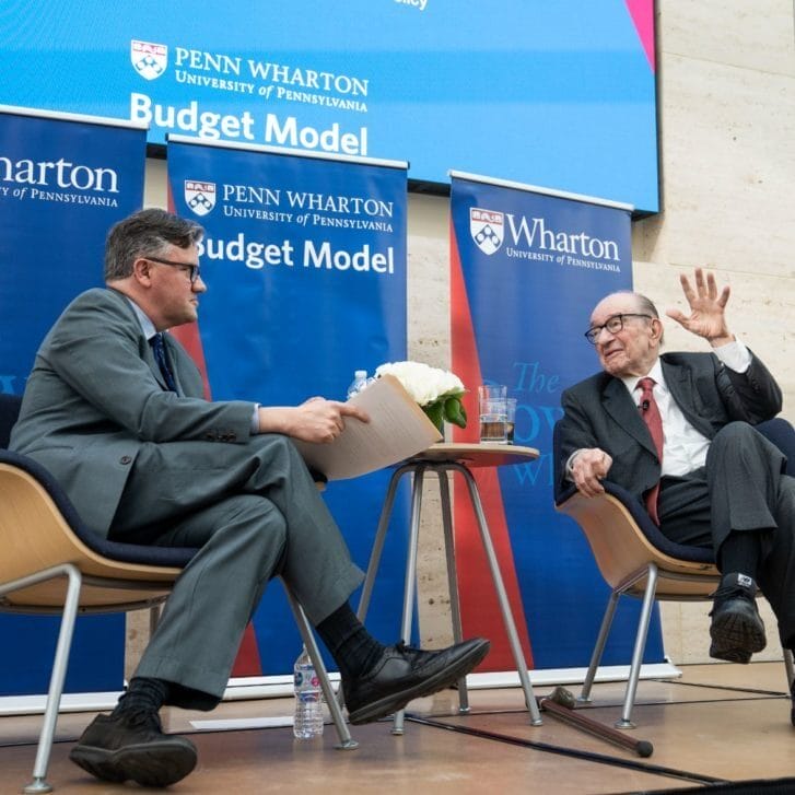 Alan Greenspan and Kent Smetters seated on a stage for a Penn Wharton Budget Model event.