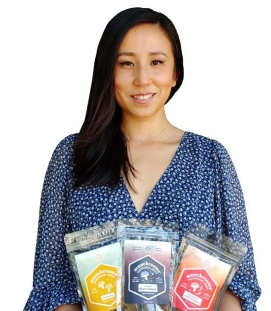 Gina Shi holding bags of Munchrooms.