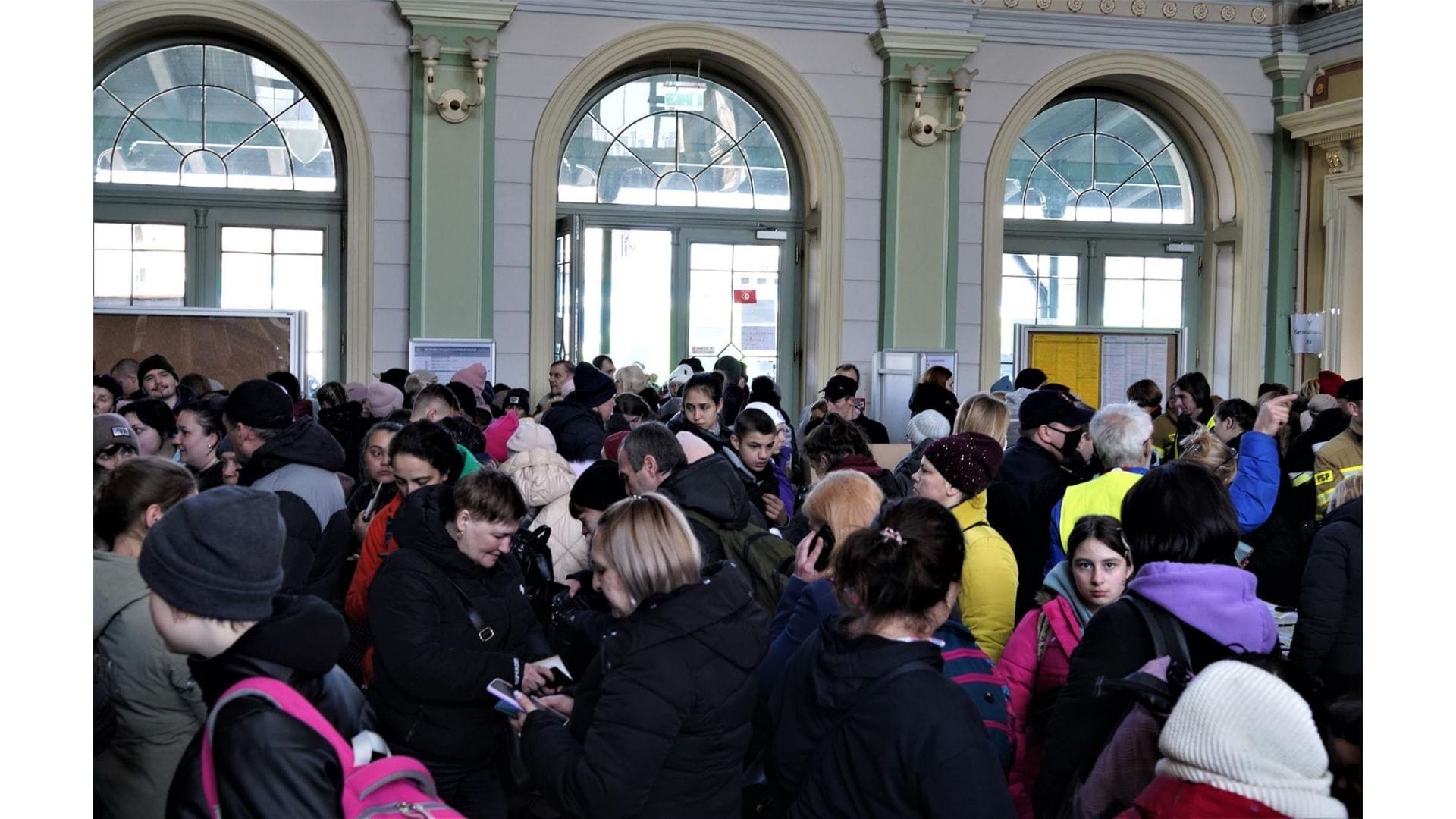 A crowd at a train station in Poland.