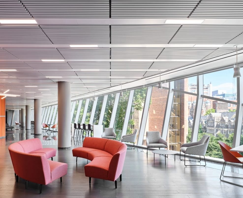 A lounge in the Academic Research Building with floor-to-ceiling windows and modern, colorful furniture.