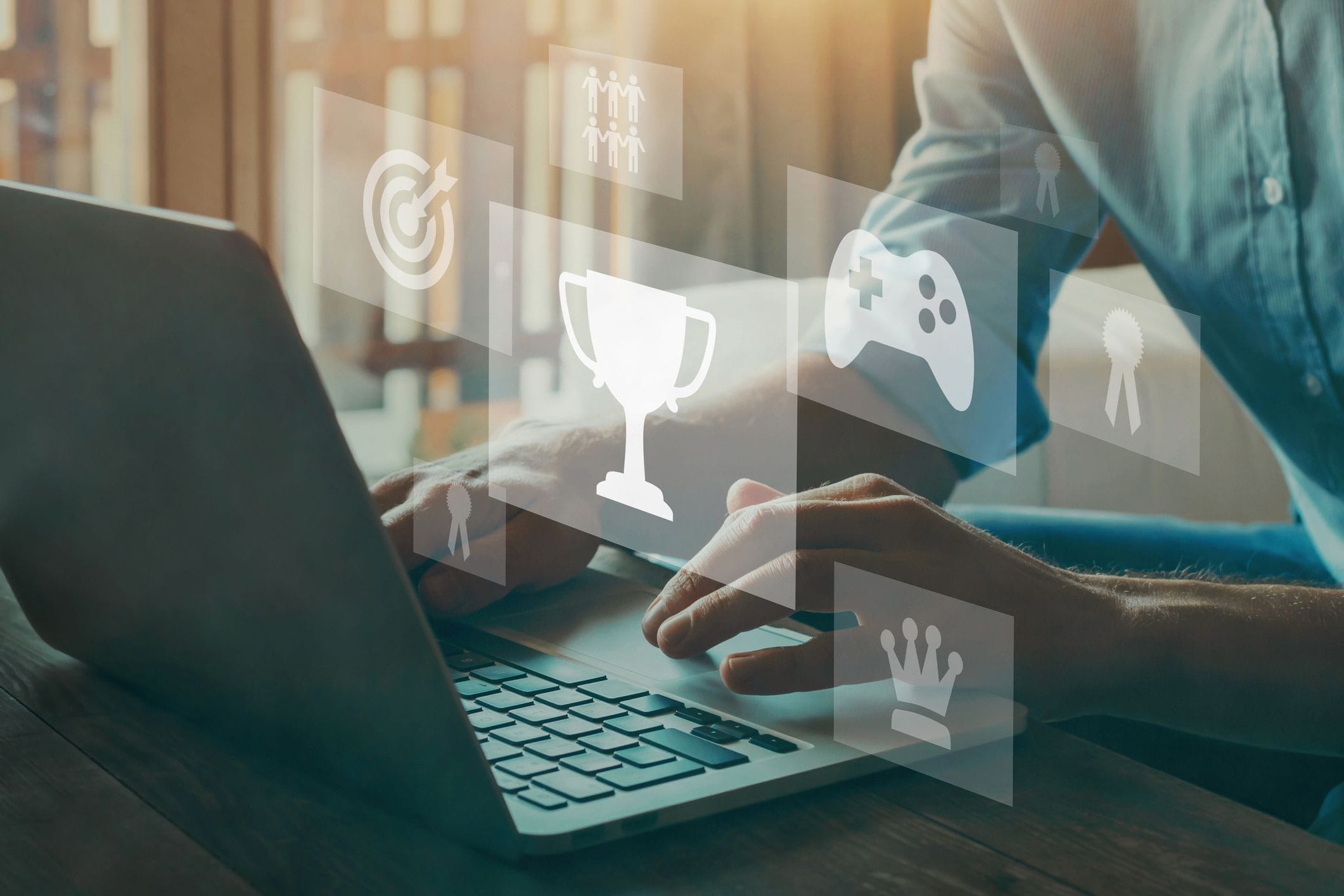 Conceptual image of a person playing educational games on a laptop and earning trophies, rewards, and more.
