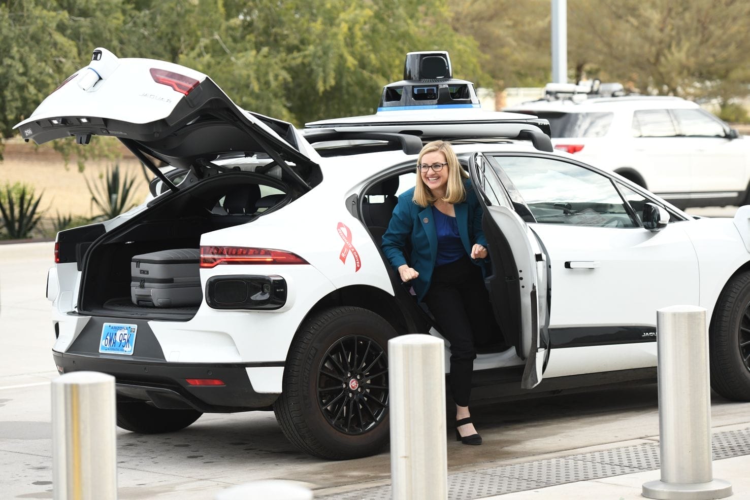 Phoenix Mayor Kate Gallego exits a Waymo self-driving car.