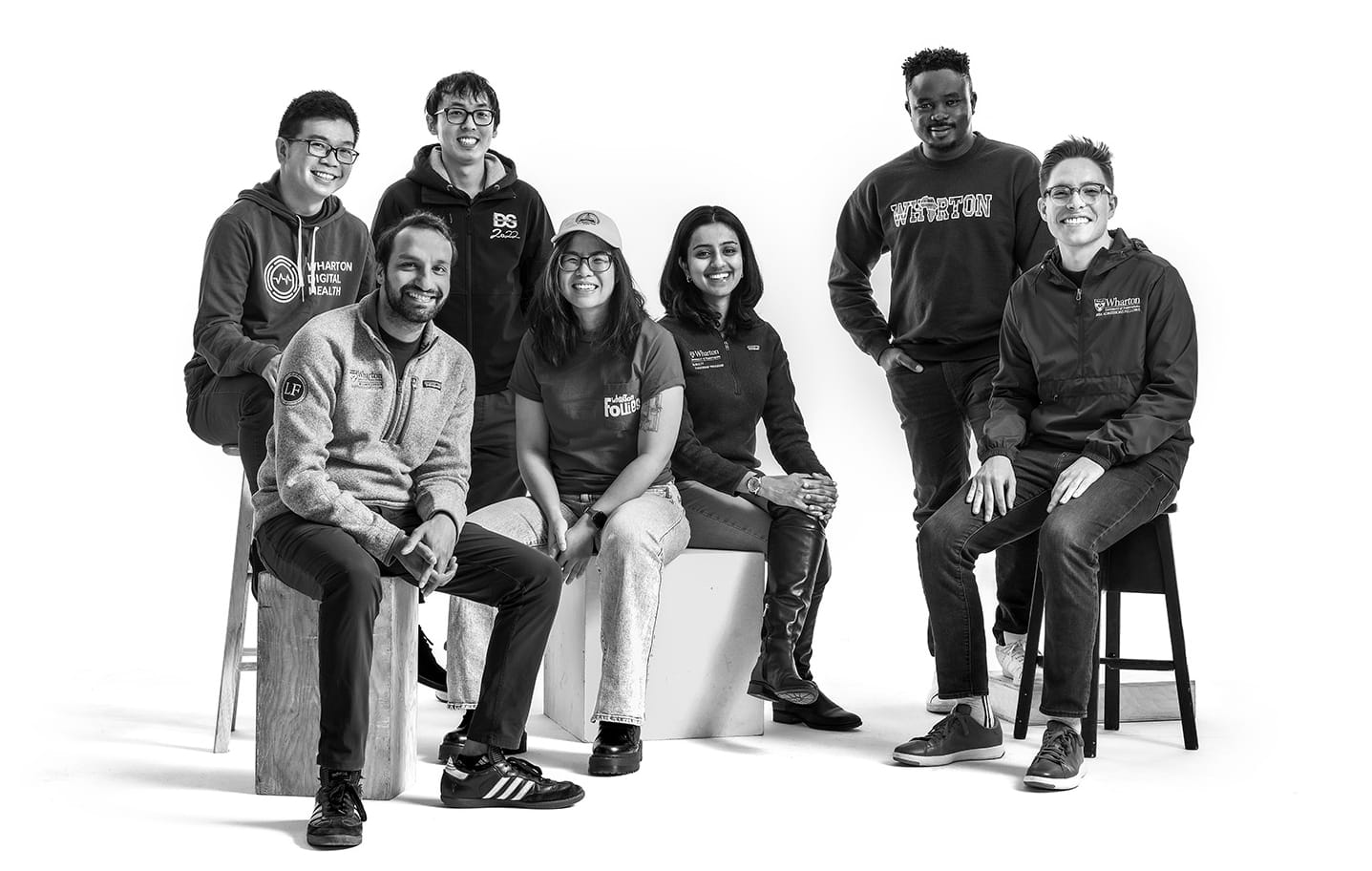 Seven students in the Wharton 1Gen club pose for a photo in Penn and Wharton gear.