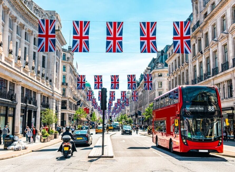 A street in London with U.K. flags hanging overhead.