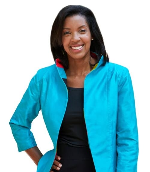 Wharton Dean Erika James poses wearing a light blue jacket and a black dress.