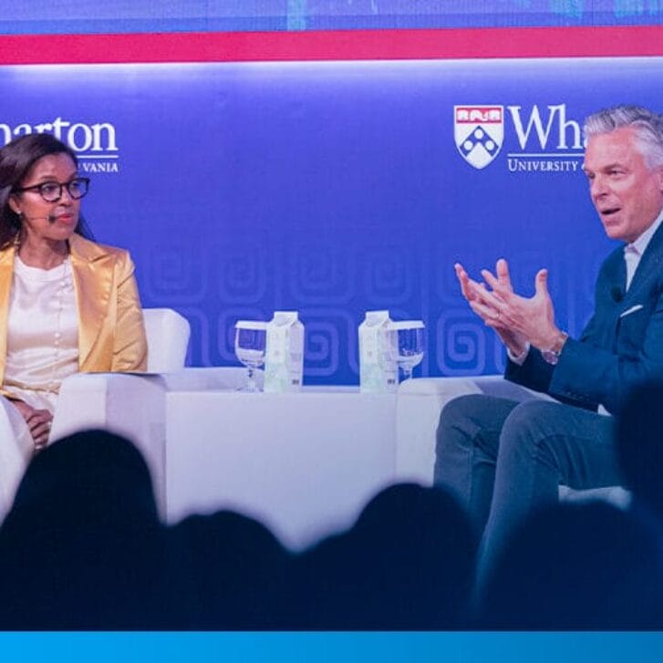 Dean Erika James with Jon M. Huntsman, Jr. on stage at the Wharton Global Forum in Singapore.