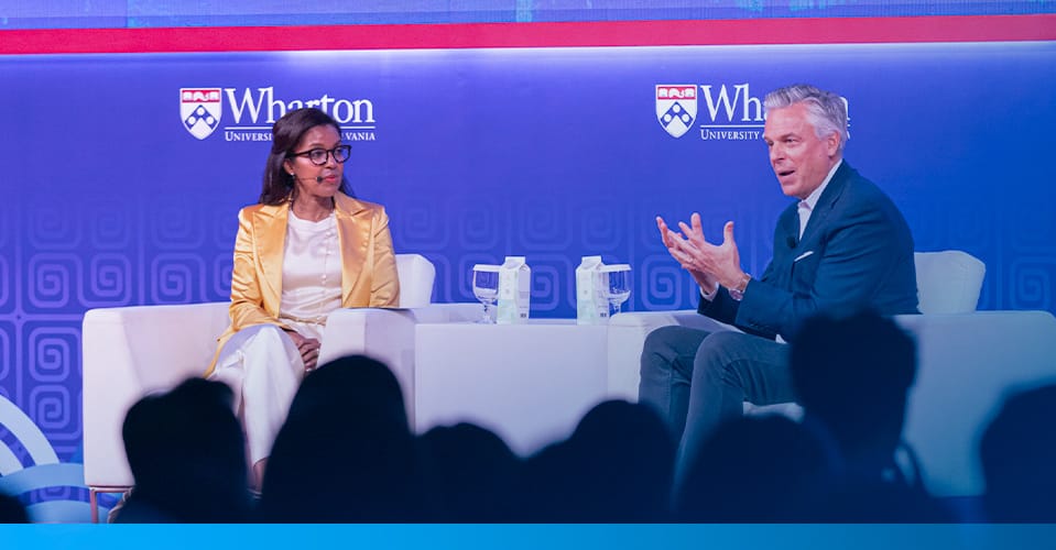 Dean Erika James with Jon M. Huntsman, Jr. on stage at the Wharton Global Forum in Singapore.