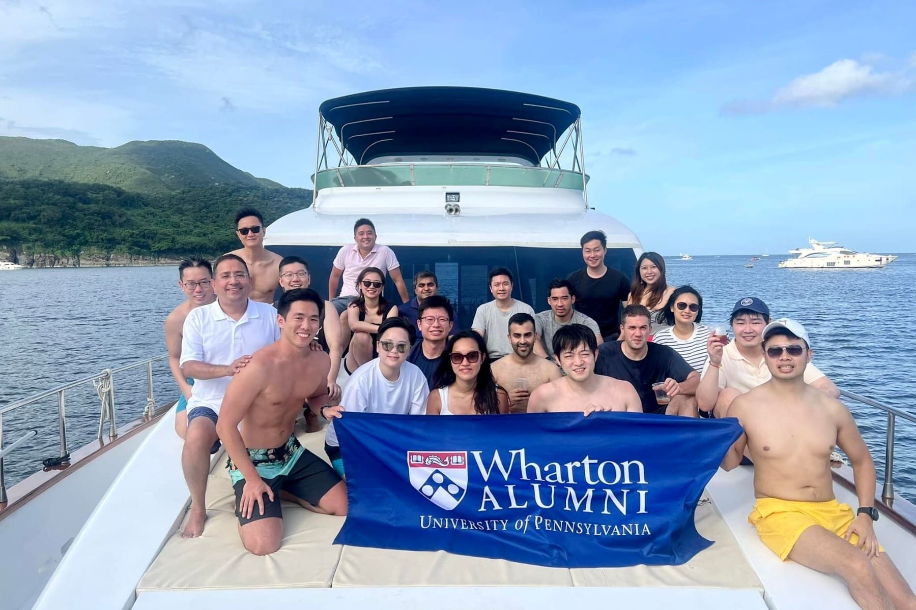 Wharton alumni gathered for a photo on a boat.