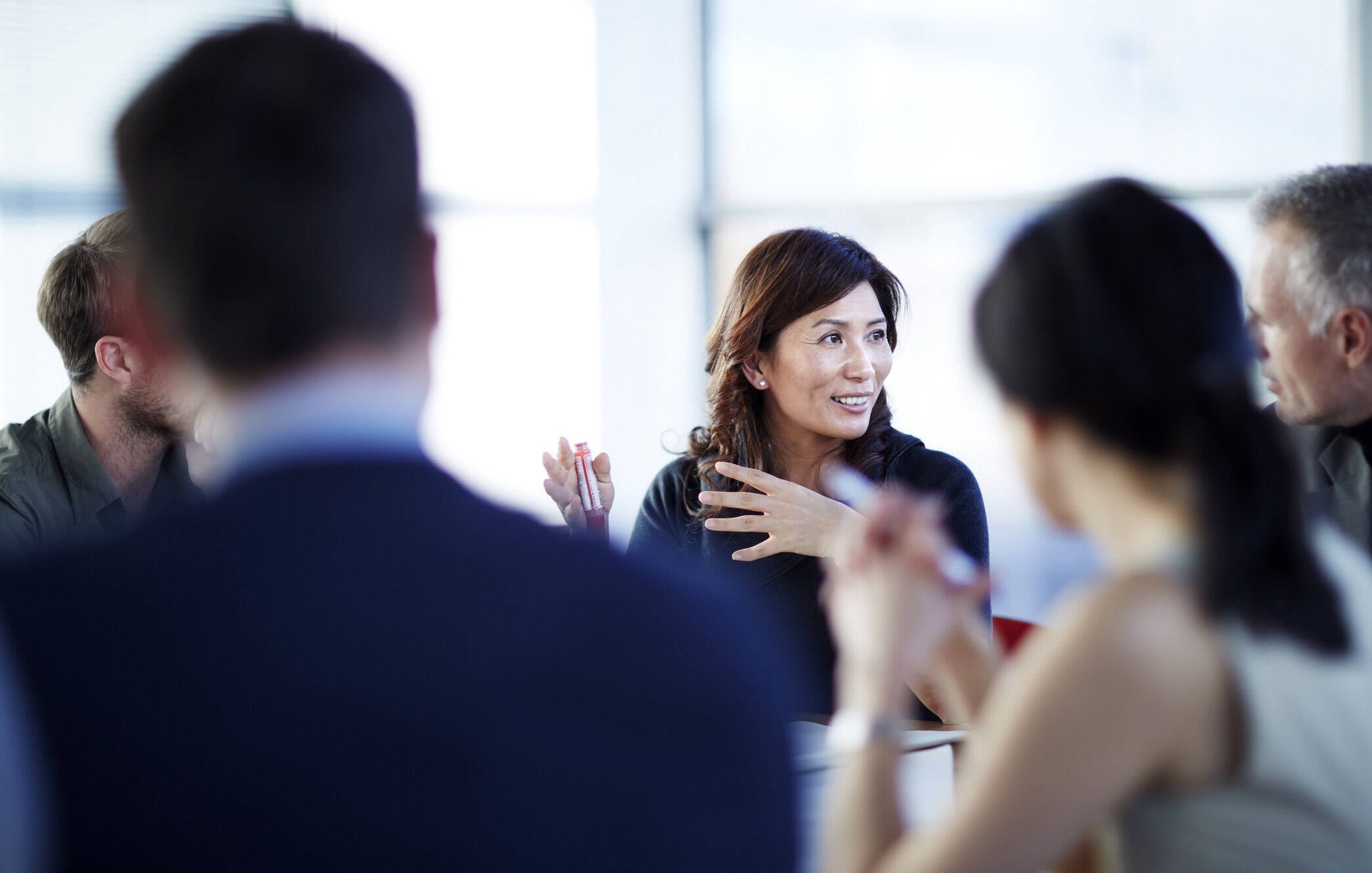 Woman gesturing in a meeting