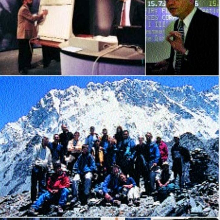 Collage of people doing different things. Picture one is of a man sitting at a desk learning from another at a whiteboard. Second picture is of a man standing explaining a concept. Middle picture is of a group of people standing together at a mountain. Bottom left picture is of people standing at steps. Bottom right picture is two men pictured together with a model between them.