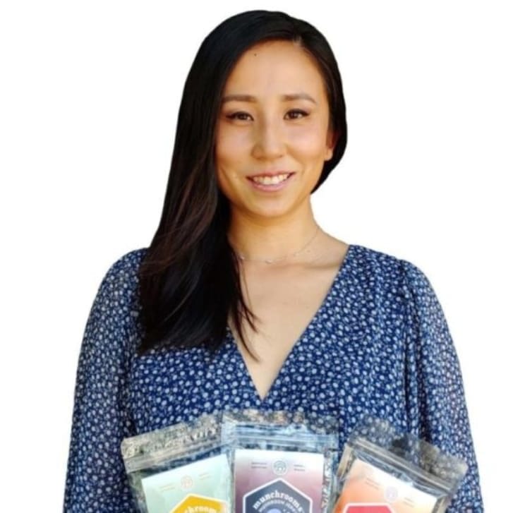 Gina Shi holding bags of Munchrooms.