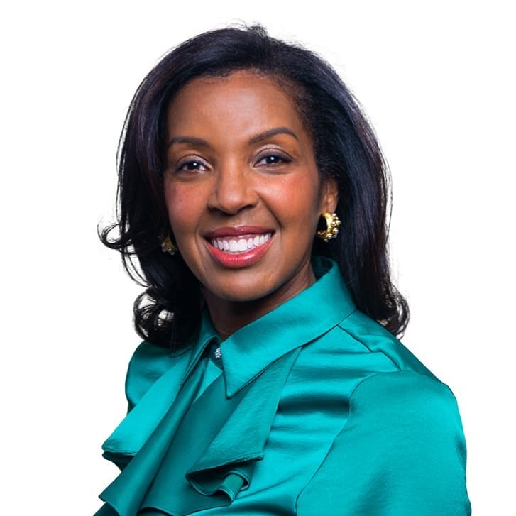 Wharton Dean Erika James poses wearing a turquoise dress shirt.