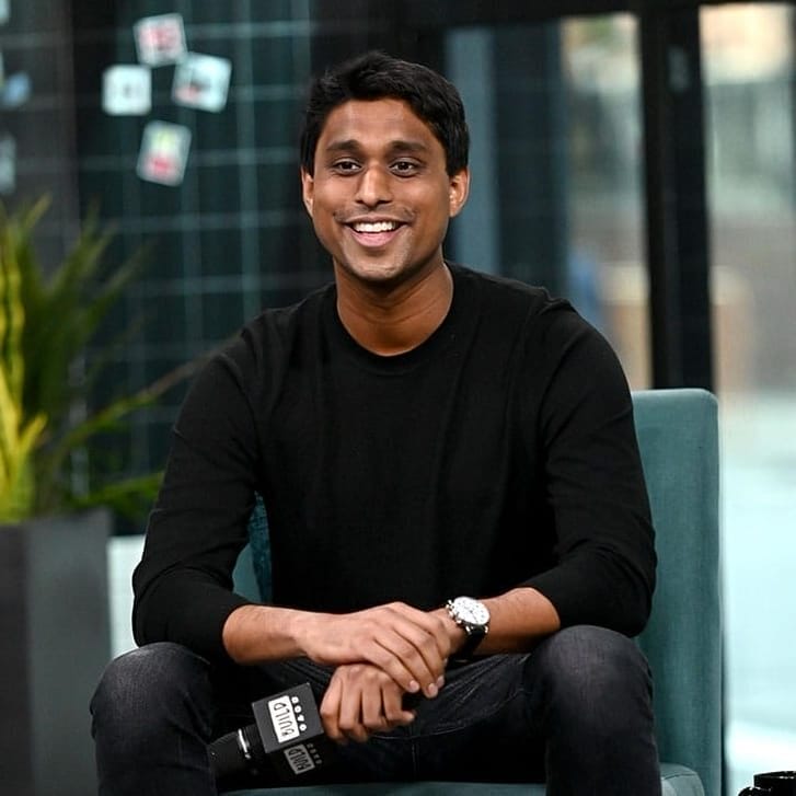 Portrait of Ankur Jain in a black shirt, black jeans, and white shoes.