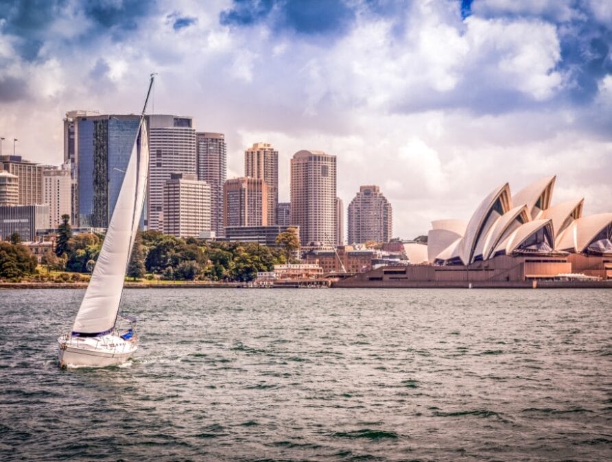 The Sydney Opera House with a sailboat in the foreground.