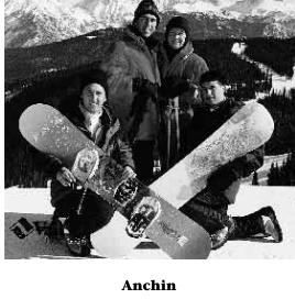 Jim Anchin, W’65, WG’66, is seen at the top of the mountain with three others as they pose with snowboards.