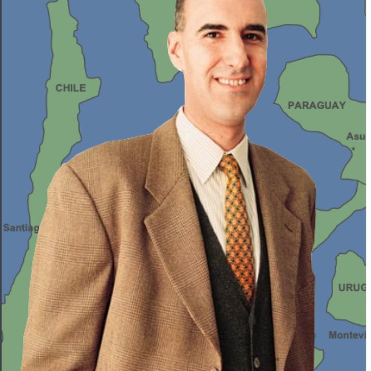 Professor Mauro Guillén stands in front of a map of South America.