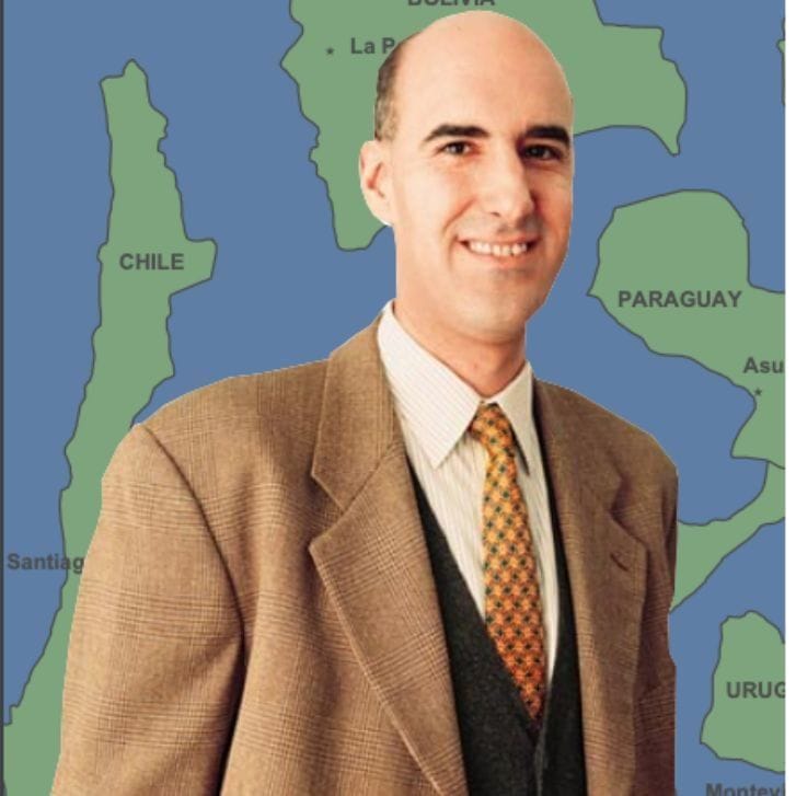 Professor Mauro Guillén stands in front of a map of South America.