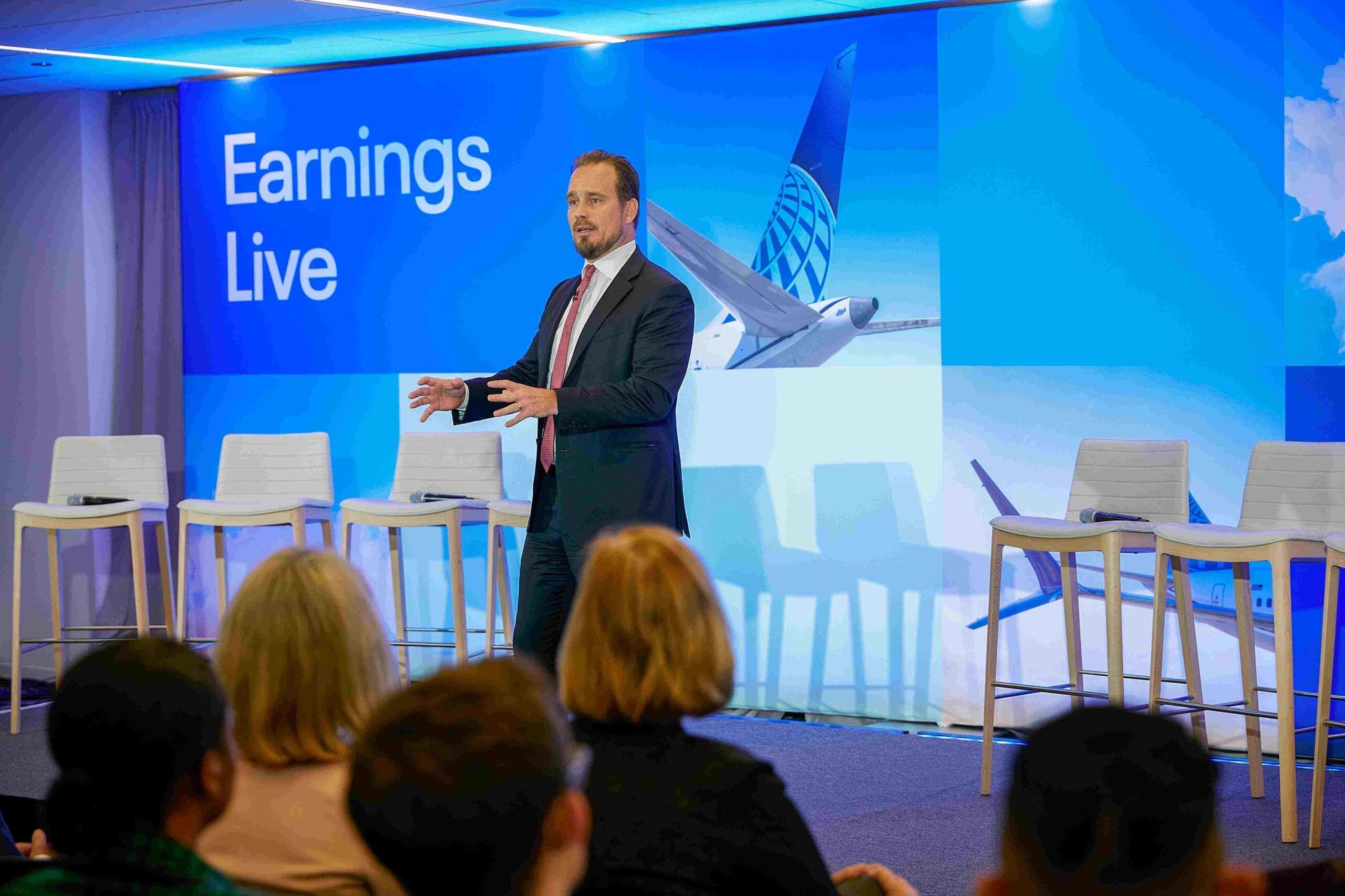 Michael Leskinen speaking on stage at a United quarterly Earning’s Live event