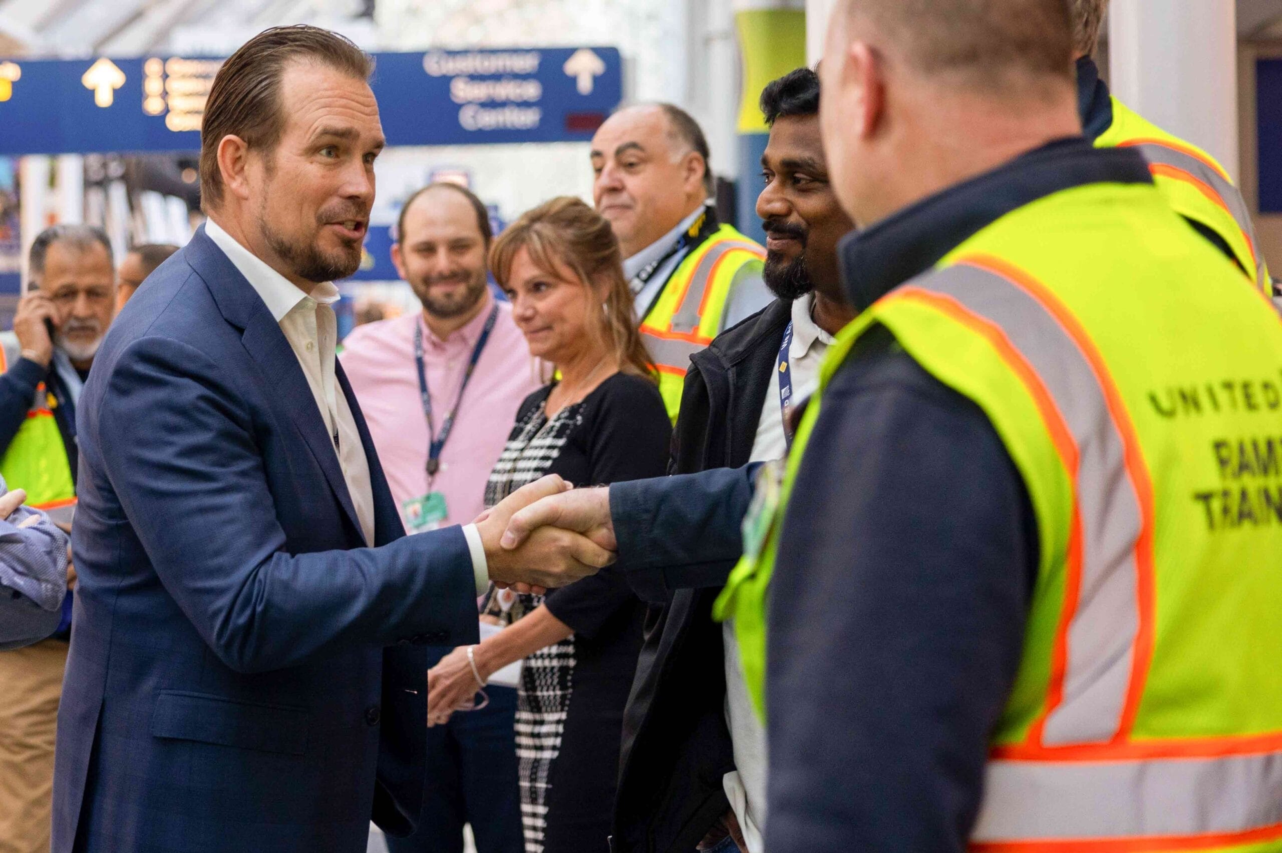 Michael Leskinen shaking hands with United employees