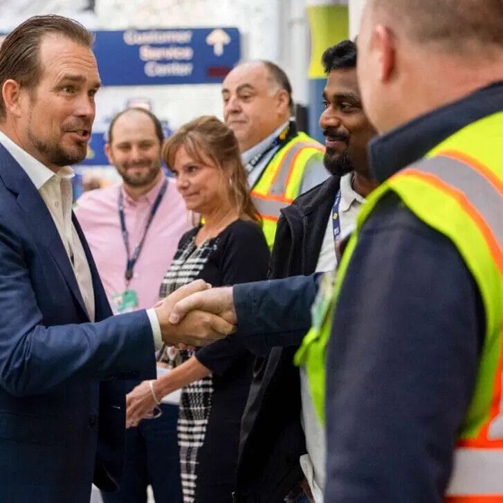 Michael Leskinen shaking hands with United employees