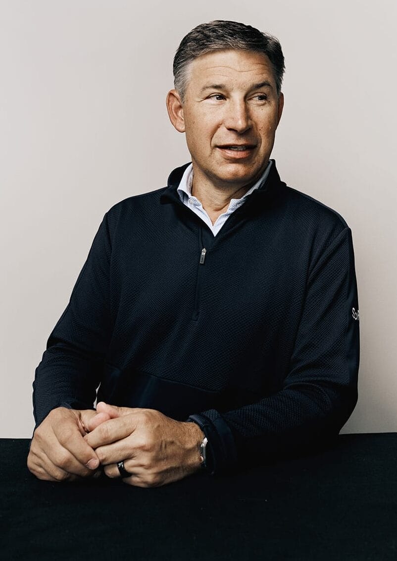 Portrait of Anthony Noto in a quarter-zip shirt looking right.