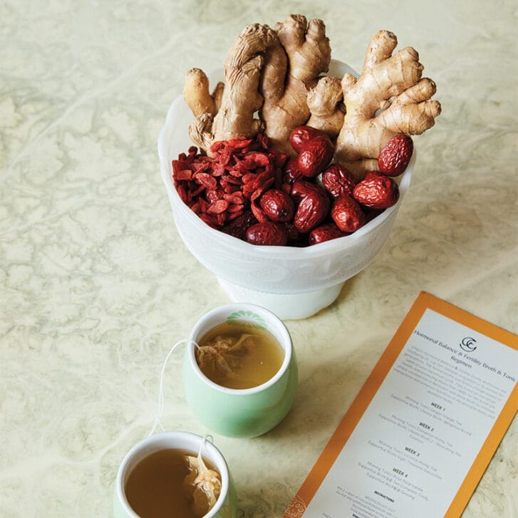 Ginger and berries in a dish on a table.