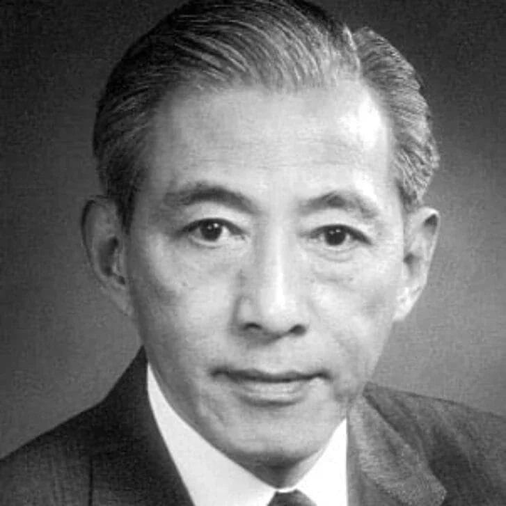 Black and white portrait of a man in a suit and tie.