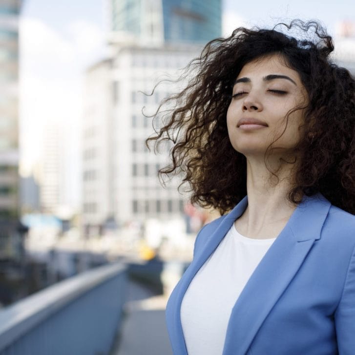 Businesswoman relaxing outdoors.