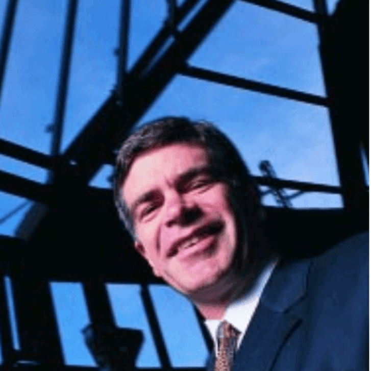 Dean Patrick Harker stands below the construction beams of Huntsman Hall.