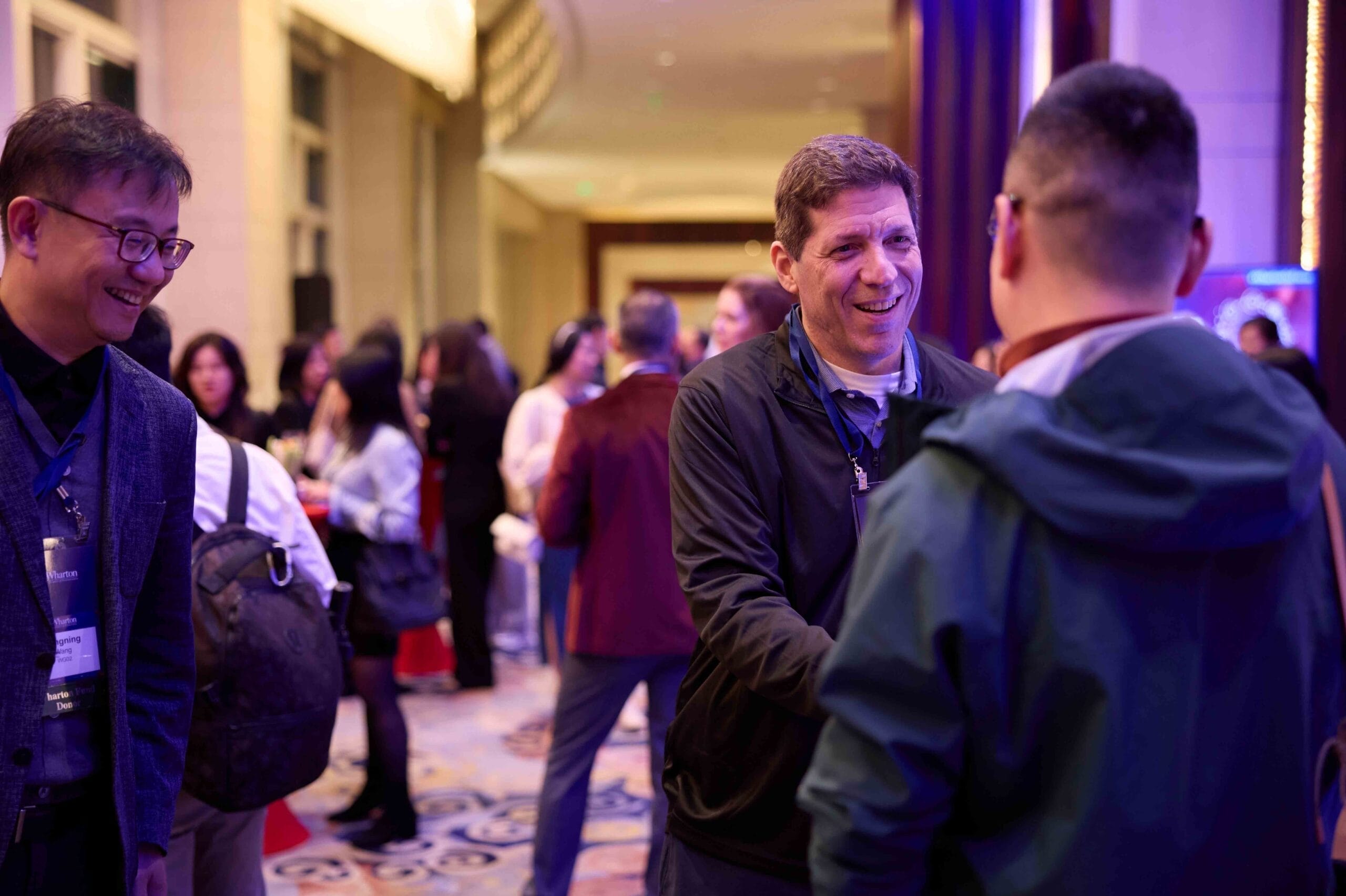 Wharton Professor Eric Bradlow shaking hands with a student in Shanghai