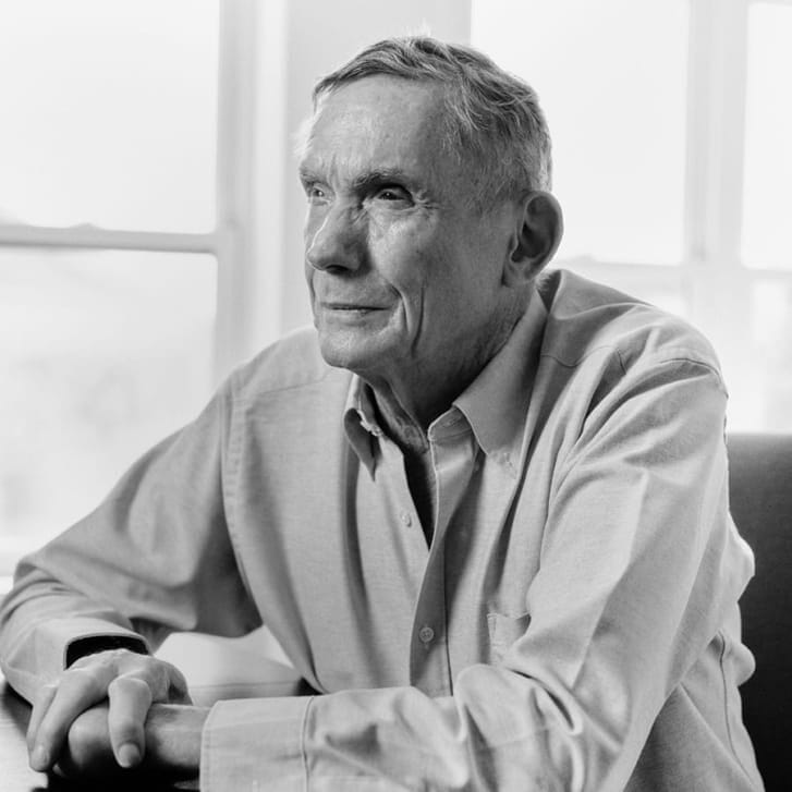 Portrait of a man facing left and wearing a button-down shirt.