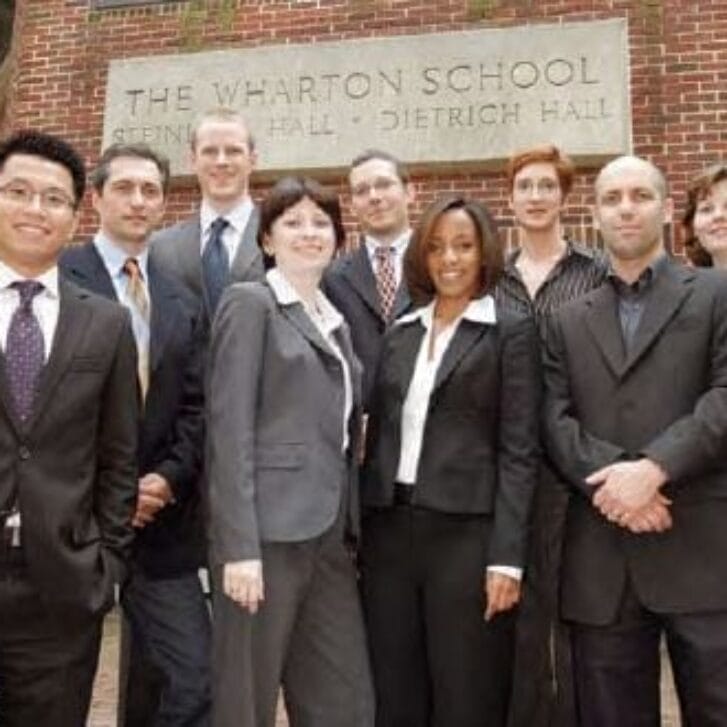 Group of people in suits in front of Wharton's Steinberg Hall-Dietrich Hall building