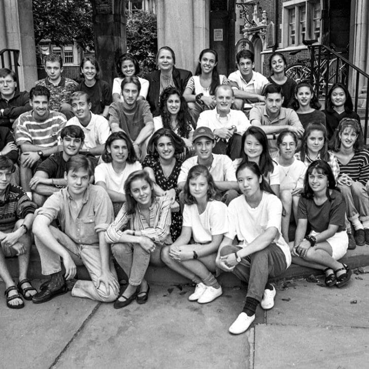 More than thirty students sit in rows on a set of stairs for a photo.