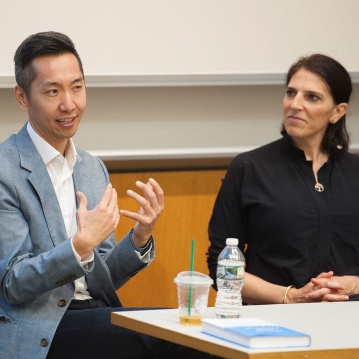 Alumni Robert Chen and Rachel Pacheco speak at the front of a classroom about their new books.