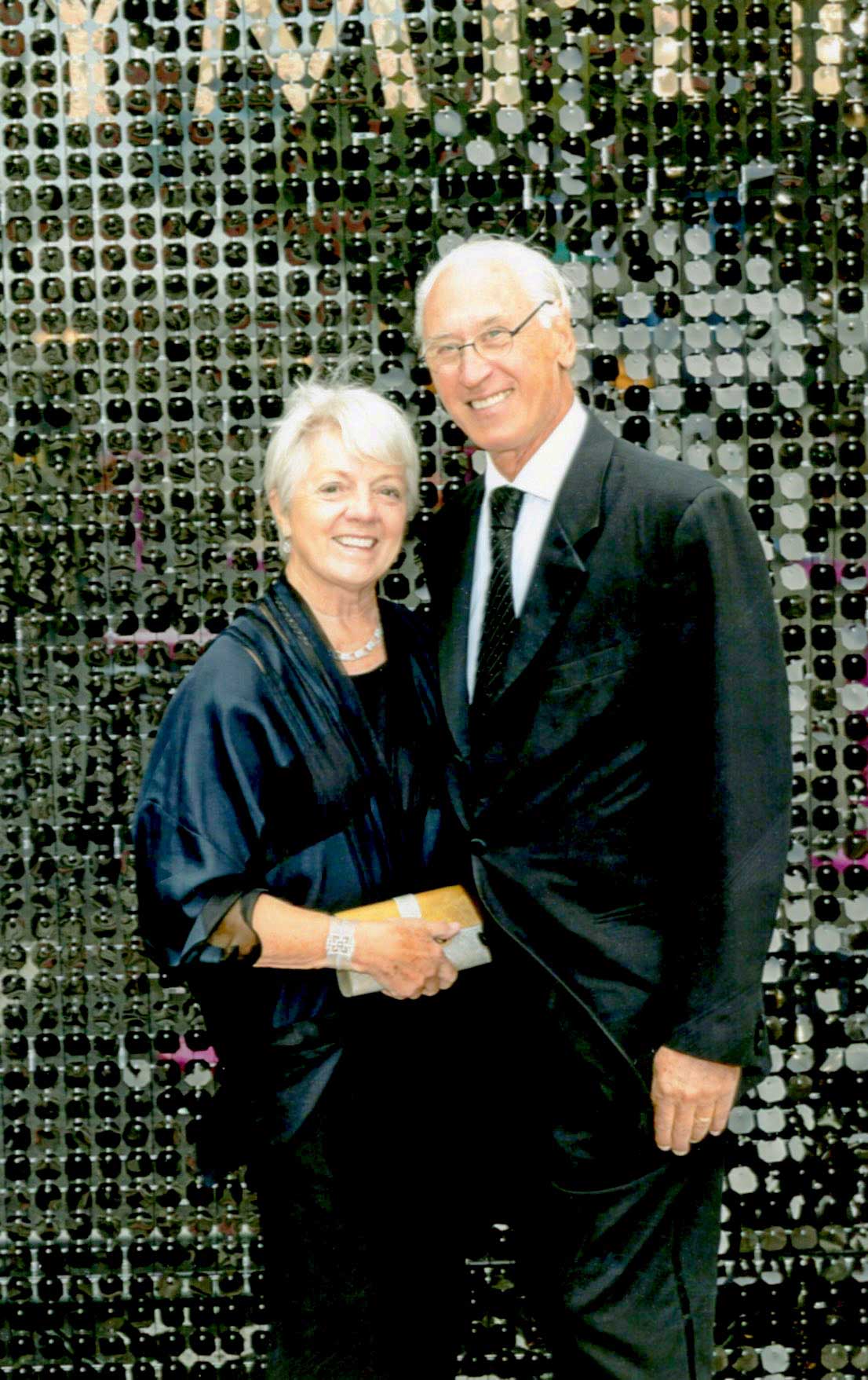 Alan Davis and Mary Lucille Dauray standing together in front of a beaded background