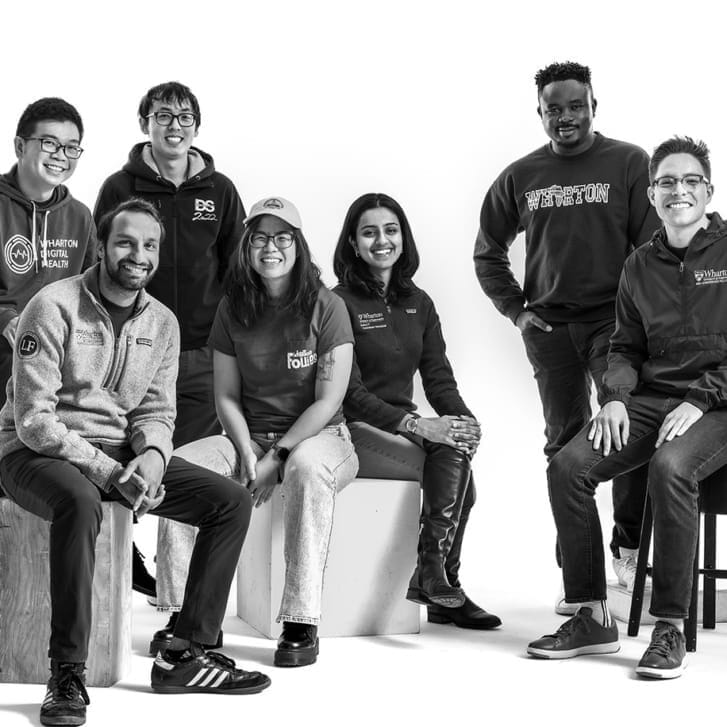 Seven students in the Wharton 1Gen club pose for a photo in Penn and Wharton gear.