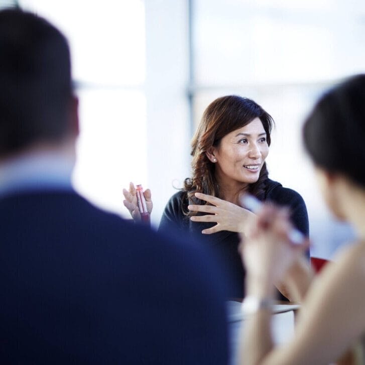 Woman gesturing in a meeting