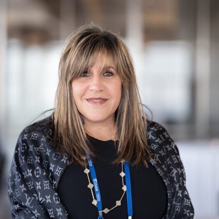 Alumna Jill Schildkraut-Katz wearing a nice shawl and a black shirt.