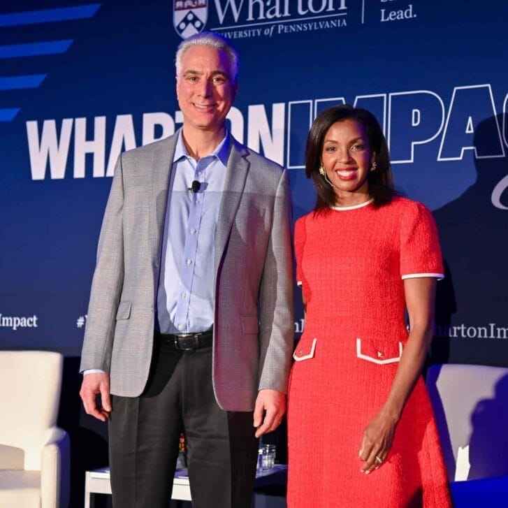 Kevin Werbach and Dean Erika James standing together onstage