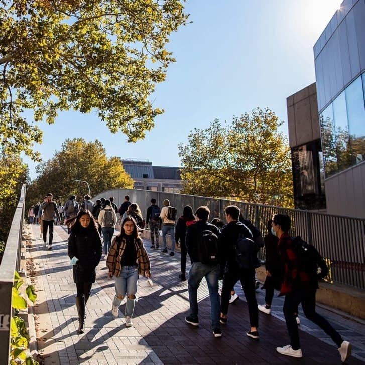 Students walking on a pathway on the University of Pennsylvania's campus.