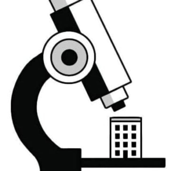 Illustration of a building sitting atop a microscope for observation.